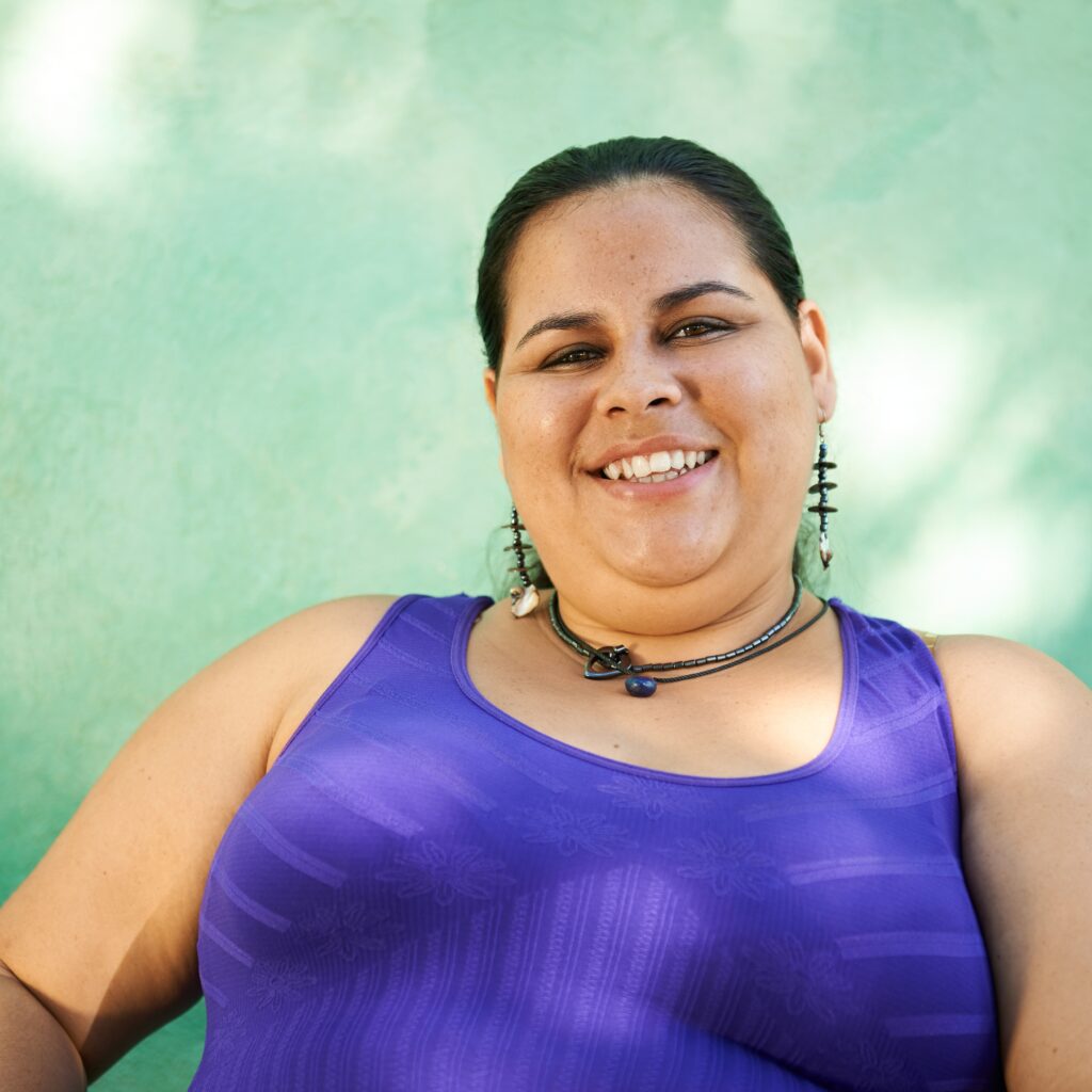 A plus size woman smiles for the camera. Learn how body image therapy in California can help you accept your body image. Search for an eating disorder therapist Orange County or body image issues in California today.