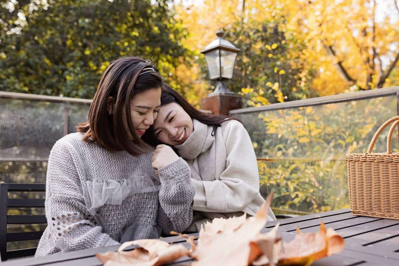 Two Asian females smiling | Woman on tablet | online therapy in California | online therapist | online eating disorder therapy | Pasadena 91199 | Palo Alto 94303 | Los Angeles, CA 90015