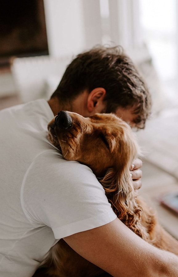 Man hugging a dog | online therapy in California | online counselor | online therapy | body image issues | eating disorder treatment | Orange County 92806 | San Francisco 94188| Pasadena 91199