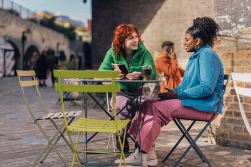 woman and friend sitting at a table outside | ptsd treatment and trauma therapy in san francisco, ca | PTSD treatment and Trauma Therapy in California | eating disorders and trauma | online therapist | IFS therapy | trauma therapist | Los Angeles, CA 90015 | Orange County 92806 | San Francisco 94188